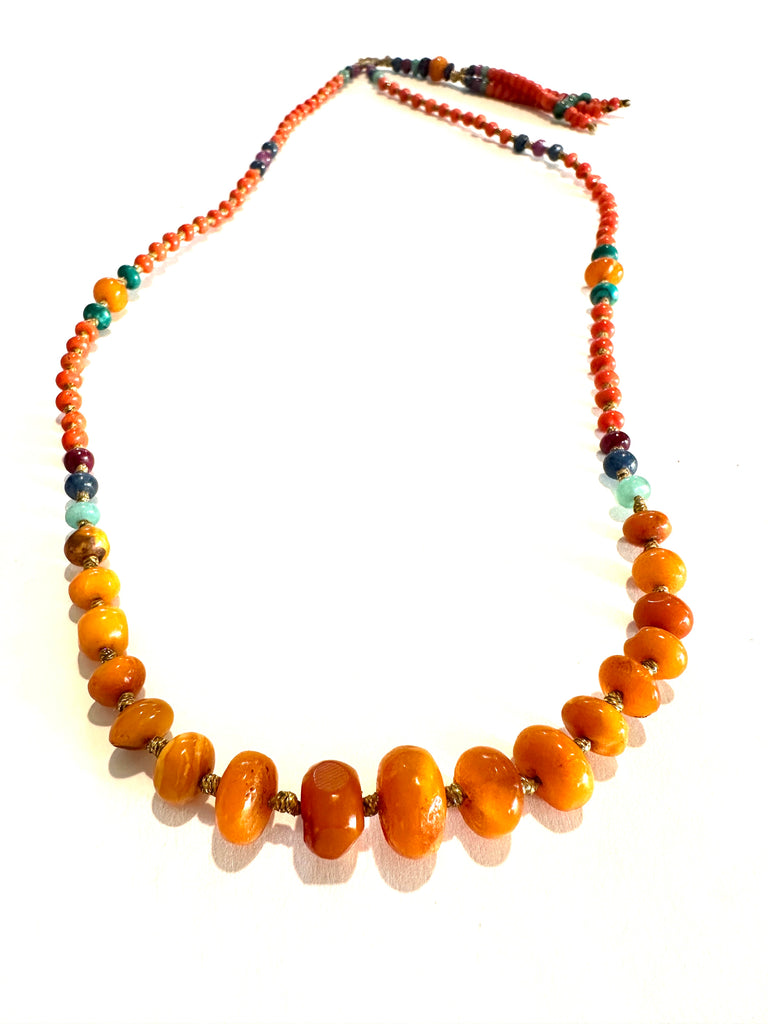 Antique amber stone with gold striomala necklace .