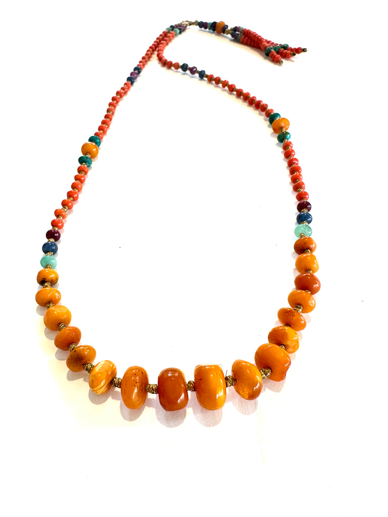 Antique amber stone with gold striomala necklace .