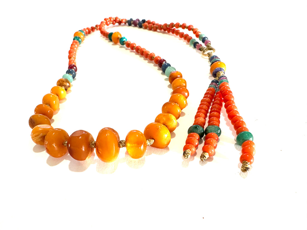 Antique amber stone with gold striomala necklace .